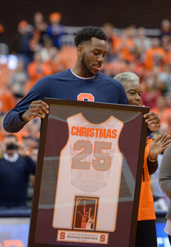 Christmas holds up his framed jersey prior to SU's game against No. 2 Virginia. 