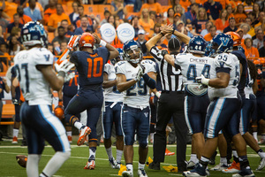 Syracuse quarterback Terrel Hunt reacts as penalty flags fly and the Villanova defense applauds his actions. Hunt was ejected shortly after for throwing a punch at linebacker Dillon Lucas, who had tackled him.