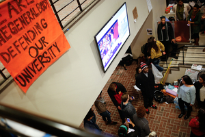 Student protesters gather in the lobby of Crouse-Hinds Hall last Friday prior to spending the weekend in the building. As the sit-in enters day 10, protesters say they're still not satisfied with SU's response to their demands.