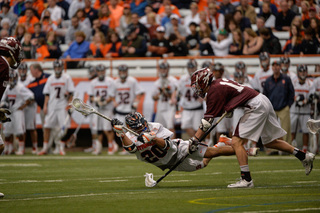Freshman midfielder Nick Weston takes a shot while diving in front of the crease. 