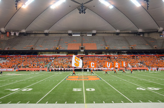 Syracuse flags are waved across the Carrier Dome field during the annual Home to the Dome event on August 21, 2014.