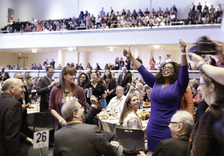 Oprah Winfrey acknowledges the crowd at the reception in Goldstein Auditorium on Monday. Winfrey later addressed the crowd of faculty, staff, students and other guests.