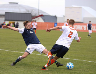 Griffith sticks his leg out trying to disrupt SU's Oyvind Alseth from advancing.