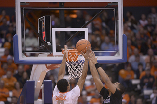 Gbinije fights for a ball at the rim with a Crusader. The senior only had two rebounds on the night.
