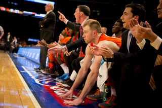 Assistant coach Gerry McNamara, shooting guard Trevor Cooney and manager Peter Corasaniti look on during the Orange's loss on Thursday night at MSG.