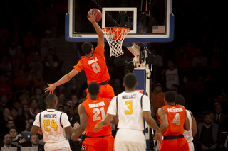 Syracuse forward Michael Gbinije finishes a dunk in transition. 