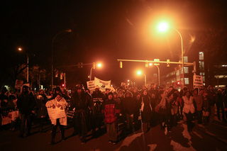 Protesters march back toward Syracuse University following a rally downtown in front of the Justice Center.