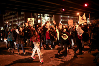 Protesters march under the Interstate 81 underpass on their way to the Patrick J. Corbett Justice Center during the 