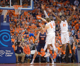 Trevor Cooney, Tyler Roberson and Christmas play tight defense. SU allowed only two points in the first 13 minutes. 