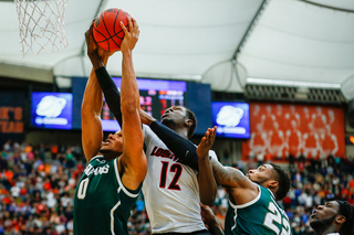 UofL's Mathiang (12) fights for a rebound in the paint.