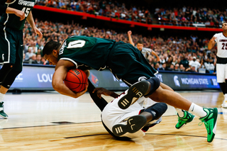 MSU's Marvin Clark Jr. tumbles for the ball after going for a rebound in the paint.