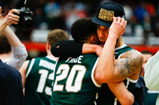 Travis Trice (left) and Valentine (right) embrace as Michigan State secures its East Regional win.