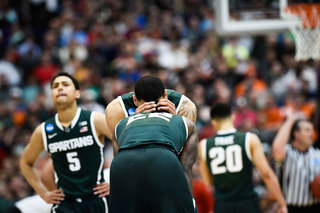 Michigan State's Denzel Valentine (45) and Branden Dawson (22) touch foreheads as Michigan State gains a lead over Louisville.