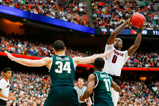 Terry Rozier goes for a shot in the paint over the Spartans defense.