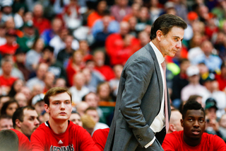 Louisville head coach Rick Pitino peers on to the court during a break in the game toward the end of the first half.