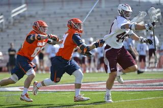 Two Syracuse players try and chase down a Colgate player. 