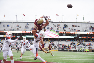 Kielan Whitner puts a hit on Boston College's Charlie Callinan as the ball soars away from both players.